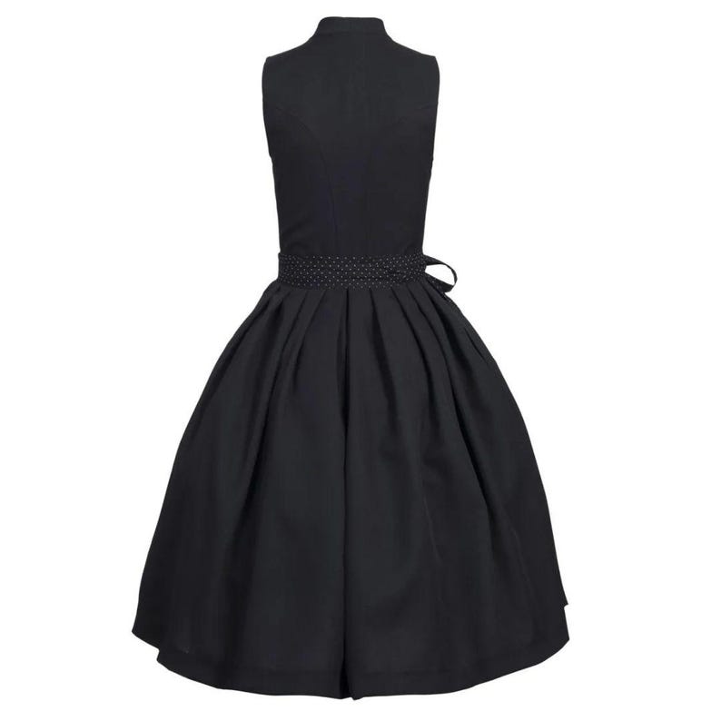 May include: A black sleeveless dress with a white polka dot trim around the waist. The dress has a full skirt and a fitted bodice.