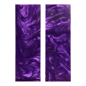 May include: Two rectangular pieces of purple resin with a swirling, pearlescent effect. The color is a deep, vibrant purple with lighter, shimmering highlights. The pieces are side-by-side against a white background.