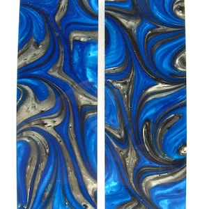 May include: Two blue and silver marbled knife scales. The scales have a swirling pattern of blue, silver, and black.