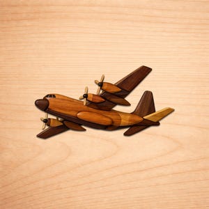 May include: A wooden airplane model with four propellers and wings, crafted from various shades of brown wood. The model is set against a light wood grain background, showcasing the detailed craftsmanship of the aircraft.