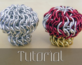May include: Two chainmail rings, one silver and one red and silver, with a gold base. The rings are spherical and have a textured appearance. The word "Tutorial" is written in a stylized font at the bottom.