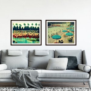 May include: Two framed vintage prints. One depicts a flock of pink flamingos in a body of water with palm trees in the background. The other shows a swimming pool scene with people, turquoise umbrellas, and lounge chairs.