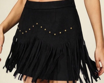 May include: Black mini skirt with fringe detail and gold-colored stud accents. The skirt has a high waist and a straight cut. The word "Snazzy" is printed in white at the top left of the image.