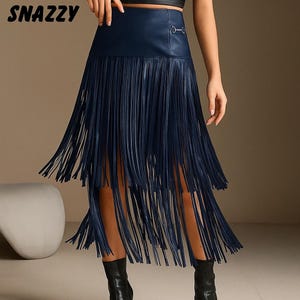 May include: A navy blue faux leather skirt with long fringe detailing. The skirt has a high waist and a decorative metal accent. The word "SNAZZY" is printed in white at the top left corner of the image.