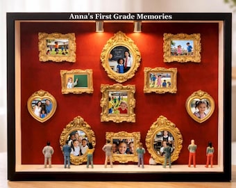 May include: A shadow box display with a red background, featuring multiple small gold-framed photos. The photos are arranged in various shapes, with miniature figures at the bottom. The text "Anna's First Grade Memories" is at the top.