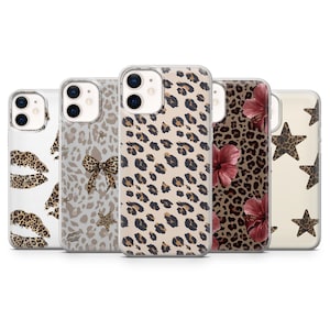 May include: Five clear phone cases with different designs. The cases display patterns including leopard print, a bow, stars, lips, and hibiscus flowers. The cases are designed for a smartphone.