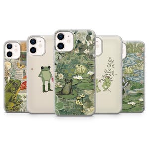 May include: Five phone cases with various designs. The cases showcase illustrations of frogs, lily pads, and botanical elements in green, beige, and white. The cases are designed to fit a smartphone.
