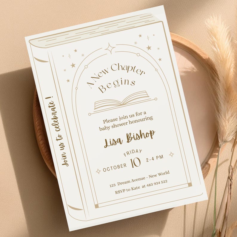 May include: A baby shower invitation designed to look like a book. The invitation is cream-colored with gold-colored text and illustrations. The text reads "A New Chapter Begins" and includes the name "Lisa Bishop" and event details.
