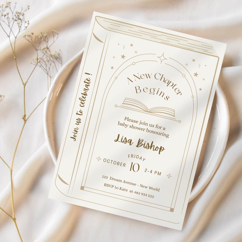 May include: Cream-colored baby shower invitation with a book-themed design. The text reads "A New Chapter Begins" with details for Lisa Bishop's baby shower, including the date, time, and location. The invitation is on a white plate.