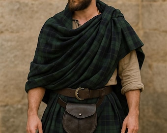 May include: A person wearing a traditional Scottish great kilt. The kilt is green and black plaid, paired with a brown leather belt and sporran. The image includes the text "GREAT KILT" at the top.