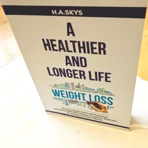 May include: A white ceramic mug with a black handle and the text "But First, Coffee" in a bold, black font. The mug is set against a neutral background, highlighting its simple design.