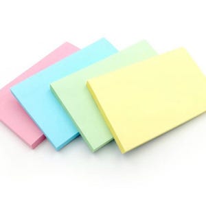 May include: Four sticky notes in different colours: pink, light blue, light green, and yellow. The notes are stacked on top of each other.
