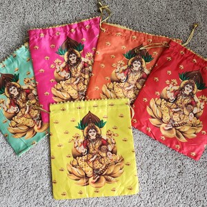 May include: A collection of drawstring bags in various colors: teal, pink, orange, red, and yellow. Each bag features a detailed illustration of a deity in gold and brown tones, with a floral border and drawstring closure.