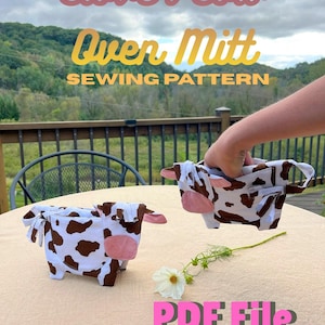 May include: Two fabric oven mitts shaped like cows with brown and white spots and pink ears. The text reads Clover Cow Oven Mitt SEWING PATTERN and PDF File Instant download. The mitts are displayed on a light-coloured surface.
