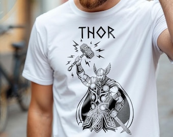 May include: White t-shirt featuring a black and white graphic of Thor, the Norse god, wielding his hammer. The word "THOR" is printed above the graphic. The shirt is a crew neck style.