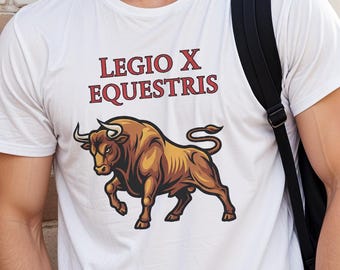 May include: White t-shirt featuring a brown and gold bull graphic with the text "LEGIO X EQUESTRIS" in maroon. The shirt is worn by a person with a black backpack, leaning against a brick wall.