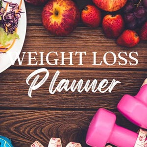 May include: A weight loss planner with a wooden background. The image features a salad, apples, strawberries, grapes, pink dumbbells, and a measuring tape.