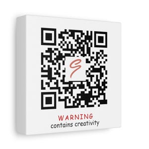 May include: A white canvas print with a black and white QR code. The QR code has a red squiggle in the center. The text below the QR code reads "WARNING contains creativity".