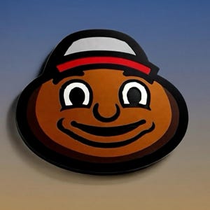 May include: A brown, smiling cartoon face with white eyes and a black outline. The character wears a black hat with a white band and a red stripe. The background is a gradient of blue and tan.