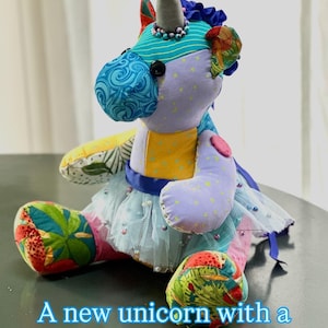 May include: A colorful stuffed unicorn with a bedazzled tutu. The unicorn has a gray horn, blue and purple body, and a multi-colored mane and tail. The tutu is light blue with pearl accents. The text on the image reads: "A new unicorn with a bedazzled tutu."