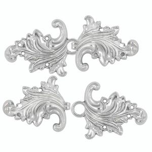 May include: Two silver-toned metal decorative clasps with a floral design. Each clasp has a loop on one end and a ball on the other end.