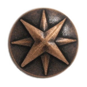 May include: A copper-coloured eight-pointed star button with a dark brown background.