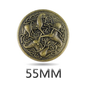 Peut inclure: Un grand bouton rond en métal doré avec un motif de nœud celtique représentant trois animaux stylisés. Le bouton mesure 55 mm de diamètre.