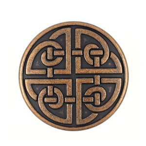 May include: A round, copper-colored metal button with a Celtic knot design. The knot is intricate and detailed, with a black background.
