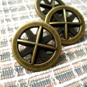 May include: Three antique gold-toned metal buttons with a starburst design. The buttons have a raised, textured center and a smooth outer edge.