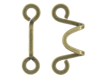 May include: A pair of antique gold metal hook and eye closures. The hook is a simple loop, and the eye is a twisted, decorative loop.