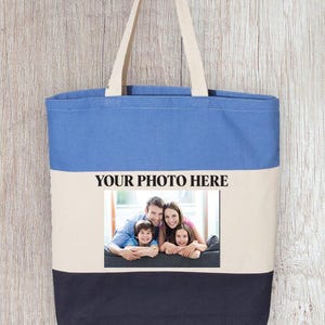 May include: A blue, beige, and black canvas tote bag with a photo of a family of four on the front. The text "YOUR PHOTO HERE" is printed above the photo.