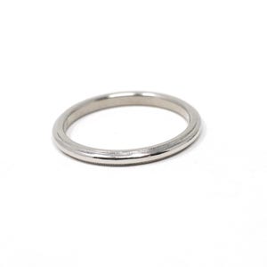 May include: A silver-colored ring with a detailed band. The ring is circular and sits on a white background. The band has a textured design around the edges. This ring is suitable for everyday wear or special occasions.