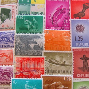 May include: A collection of vintage Indonesian postage stamps featuring various designs, including a pig, a palm tree, a train, a plane, and a truck. The stamps are in various colours, including red, green, blue, and yellow. The stamps are all in good condition and have been carefully preserved.