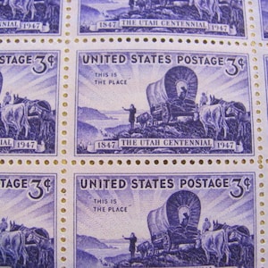 May include: Sheet of vintage United States postage stamps. Each stamp features a blue illustration of a covered wagon, oxen, and a person. Text includes "United States Postage 3¢", "This is the Place", and "Utah Centennial 1947".