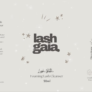 May include: A white label with black text for a lash cleanser product called "Lash Bath Foaming Lash Cleanser" by "lash gaia". The label also includes a list of ingredients and directions for use. The product is cruelty-free, oil-free, and recyclable.