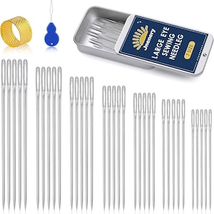 May include: A collection of sewing supplies, including a gold thimble, a blue needle threader, and a variety of silver sewing needles. A metal tin contains more needles, with the text "LARGE EYE SEWING NEEDLEG" and "7 SIZE".