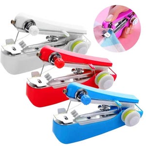 May include: Three handheld sewing machines in white, red, and blue. Each device features a metallic base, a tension dial, a needle mechanism, and a small spool of thread. A circular inset shows a pink handheld sewing machine stitching fabric.