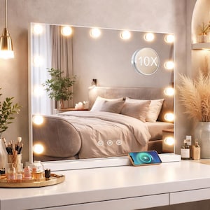 May include: A white vanity mirror with a rectangular shape, featuring a series of circular lights around the perimeter. The mirror has a 10X magnification feature and a built-in wireless charging pad for a smartphone. The mirror is set on a white vanity table.