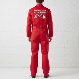 May include: A vibrant red racing jumpsuit featuring the text "YOUR RACE TEAM PIT CREW" and two crossed checkered flags on the back. The jumpsuit has long sleeves and a zip. The model is wearing black shoes.