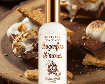 May include: A white cylindrical perfume bottle with a gold cap, featuring the text SOLIVARA Sugarfire S'mores, a graphic of a campfire, and the text Perfume Milk 100 mL. The label design is in a metallic bronze colour on a white background.