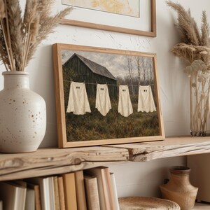 Phantom clothesline painting printable wall decor — moody countryside Halloween aesthetic with soft vintage art style