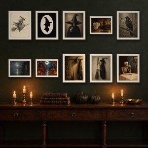 May include: A gallery wall arrangement of ten framed prints featuring Halloween-themed imagery including a witch on a broom, a silhouette, a raven, a skeleton drinking coffee, and spooky landscapes, displayed above a dark wooden console table with candles.