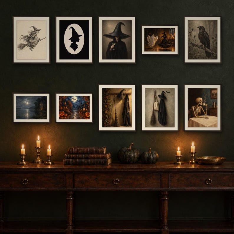 May include: A gallery wall arrangement of ten framed prints featuring Halloween-themed imagery including a witch on a broom, a silhouette, a raven, a skeleton drinking coffee, and spooky landscapes, displayed above a dark wooden console table with candles.