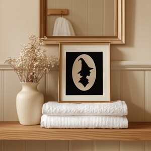 Seasonal spell caster artwork printable for Halloween — black profile cutout on cream oval minimalist wall hanging