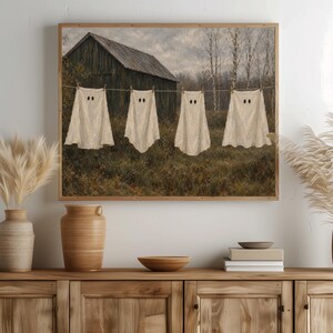 Hanging ghosts on clothesline printable art for entryway — vintage rustic countryside scene with weathered barn backdrop