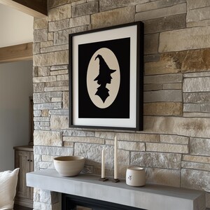 Magic practitioner silhouette wall art for kitchen — cream-backed black portrait cameo with timeless October vibes
