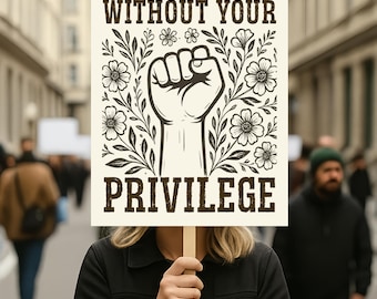 May include: A person holding a sign with the text "FIGHT FOR THOSE WITHOUT YOUR PRIVILEGE". The sign features a raised fist graphic surrounded by floral elements. The background shows a street scene with other people.