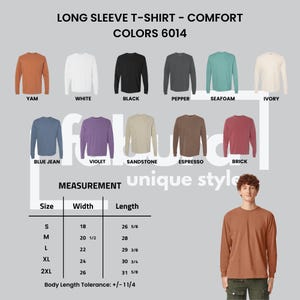 May include: A long sleeve t-shirt color chart displaying eleven options: yam, white, black, pepper, seafoam, ivory, blue jean, violet, sandstone, espresso, and brick. A size chart lists widths and lengths in inches for sizes S through 2XL.