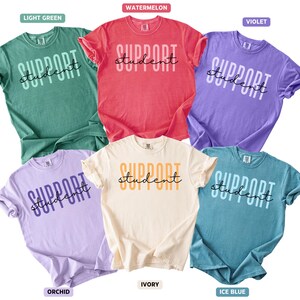 May include: Six t-shirts in a range of colours: light green, watermelon, violet, orchid, ivory, and ice blue. Each shirt displays the words "SUPPORT student" in a contrasting colour.