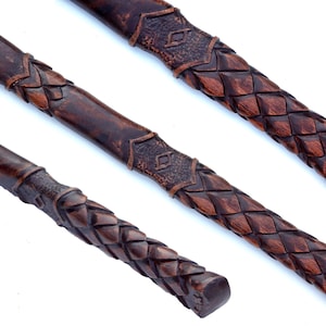 May include: Three dark brown, carved wooden handles with intricate woven and geometric patterns. The handles are displayed at different angles, showcasing the detailed craftsmanship and texture of the wood.